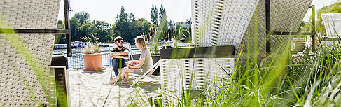 Two students in beach chairs on the Wilhelminenhof campus